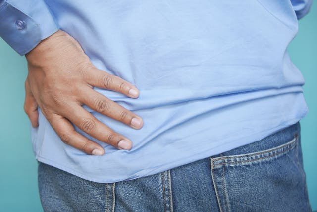 man holding hip