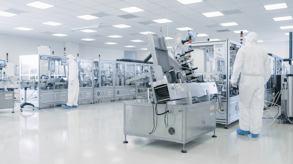 Sterile High Precision Manufacturing Laboratory where Scientists in Protective Coverall's Turn on Machninery, Use Computers and Microscopes, doing Pharmaceutics, Biotechnology Semiconductor Research.