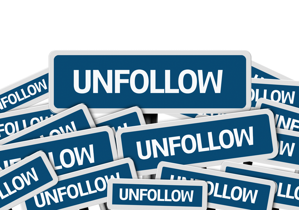 Unfollow written on multiple blue road sign