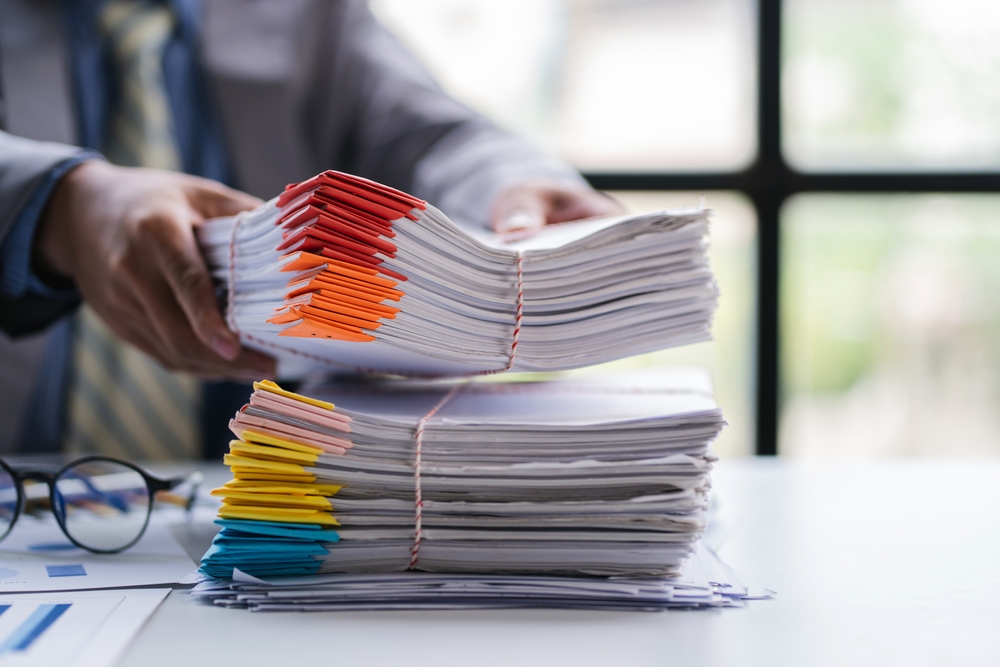 business documents businessman check legal document review Prepare documents or analysis reports, tax items, accounting documents, data contracts, office partner agreements.