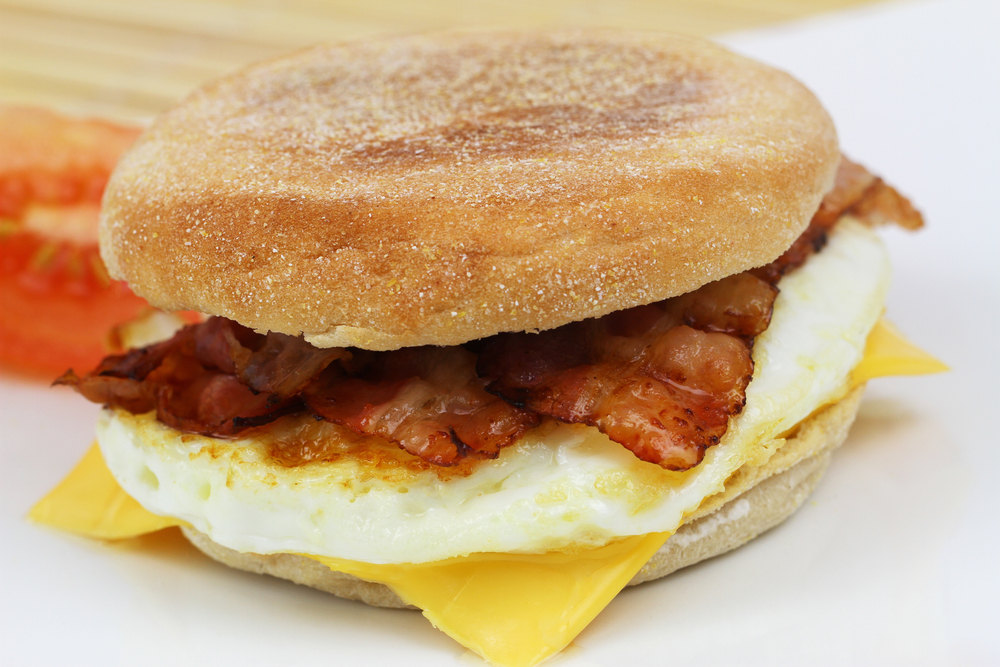 Muffin with fried egg and bacon, closeup