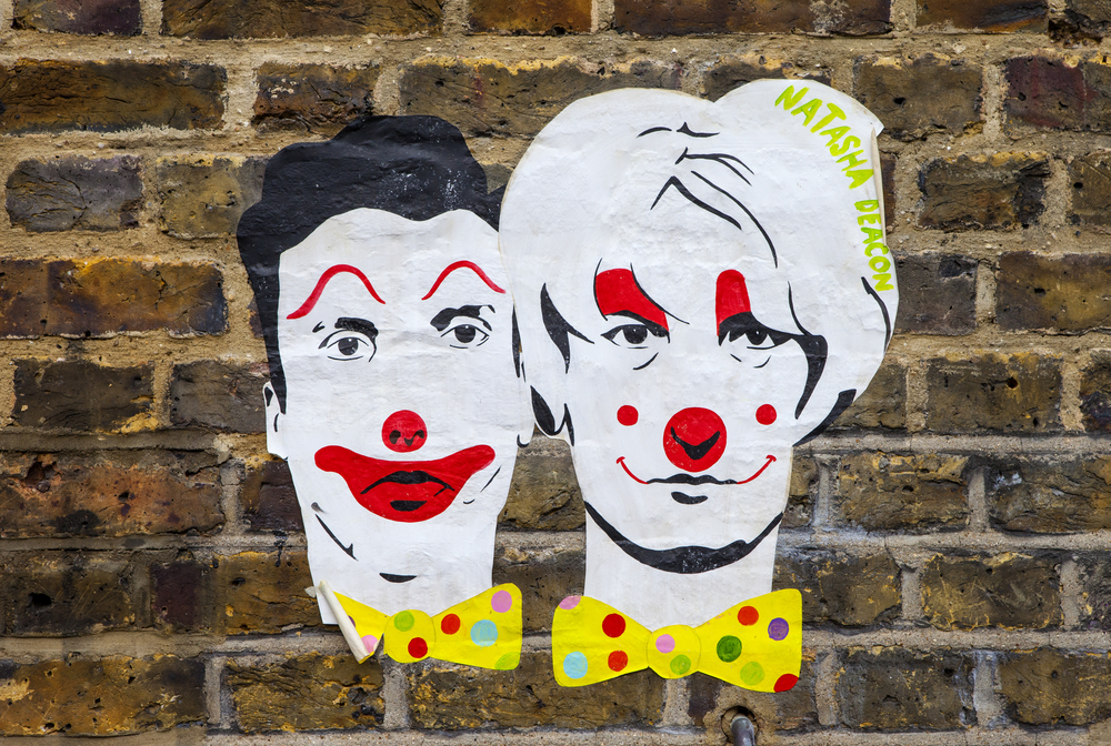 LONDON, UK - JANUARY 13TH 2016: A paste-up urban artwork by Natasha Deacon on a wall in East London, on 13th January 2016. The paste-up depicts infamous Myra Hindley and Ian Brady as clowns.