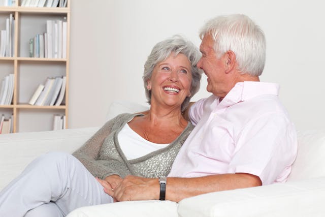 Happy senior couple sitting on a couch