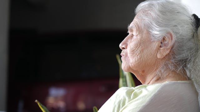 Elderly woman sitting alone