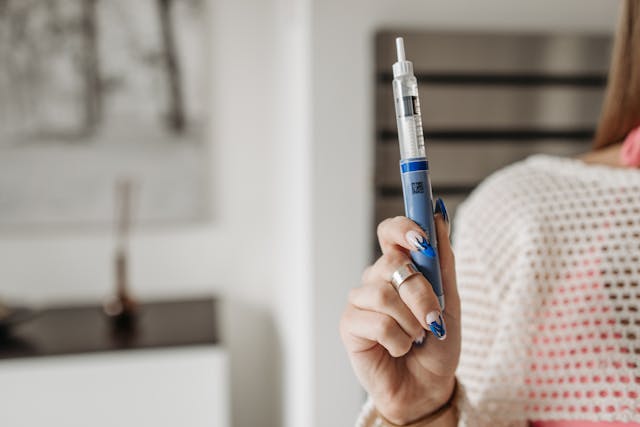 Woman holding an Ozempic pen