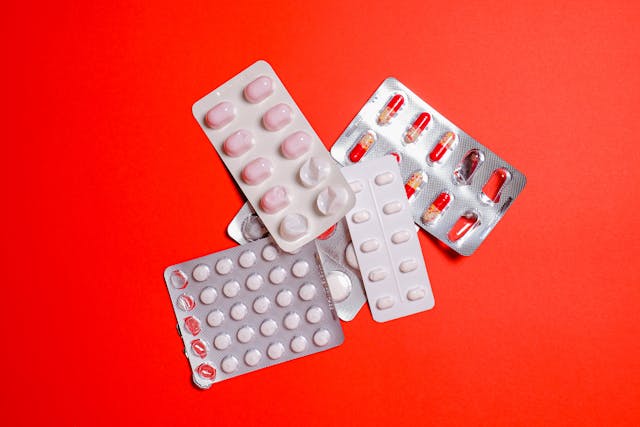Range of pills on red background