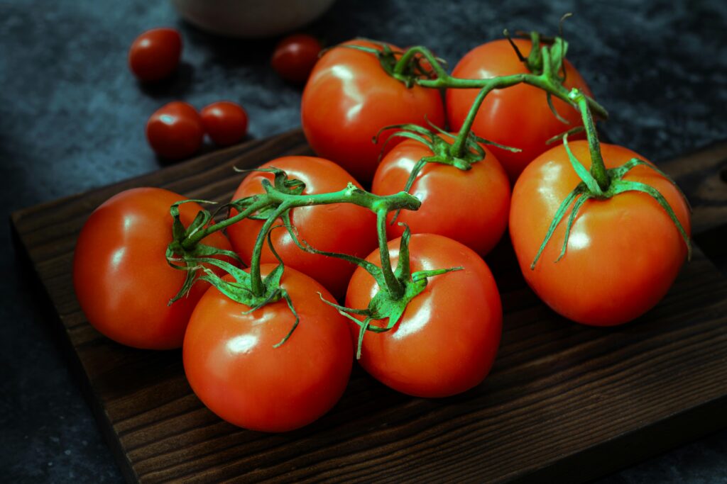 Fresh Vine Tomatoes on Rustic Wooden Board
