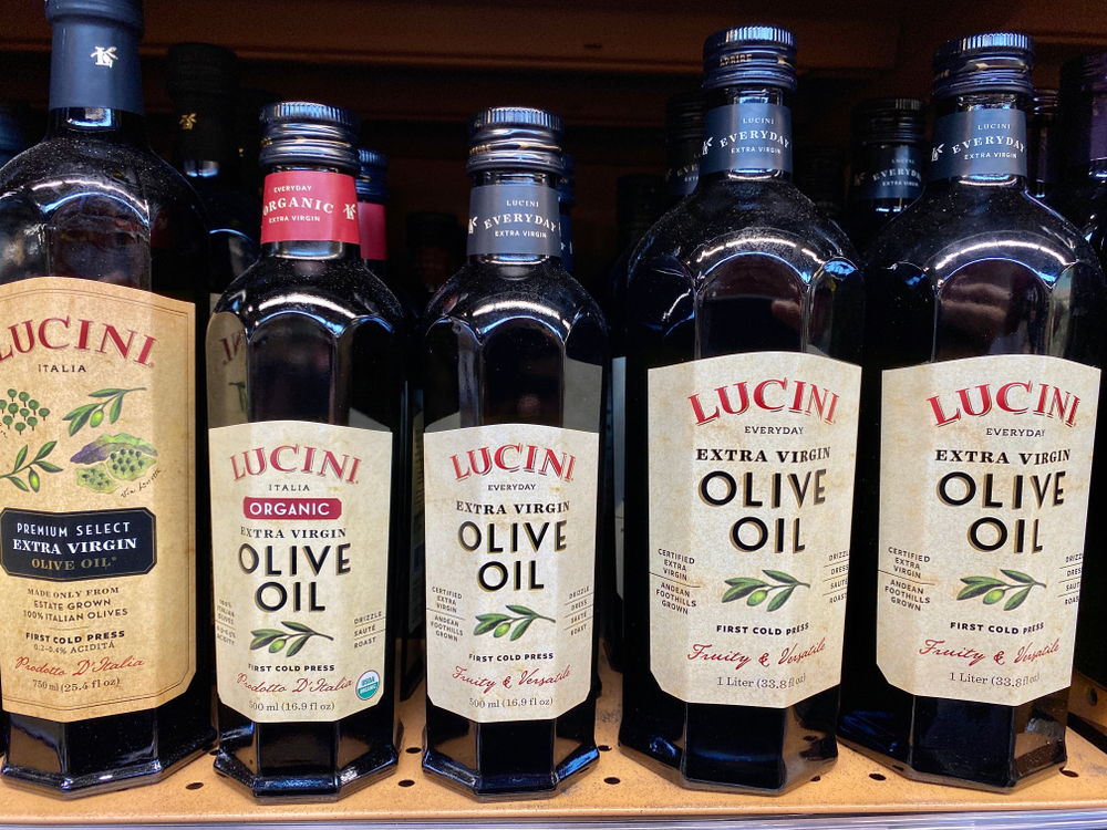 San Jose, CA - December 15, 2019: Lucini brand extra virgin olive oil in black bottles. Cold pressed and organic. 