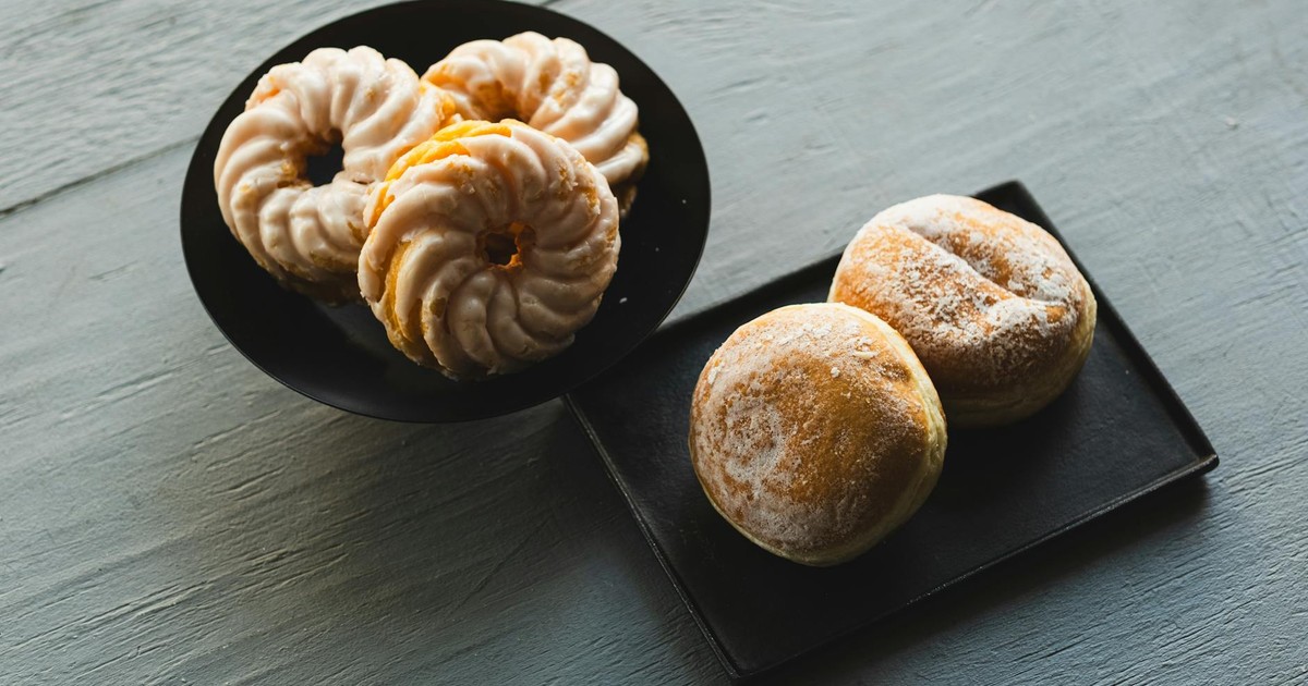 Indulge in a tasty selection of German pastries including donuts and Berliner on a rustic wooden table.