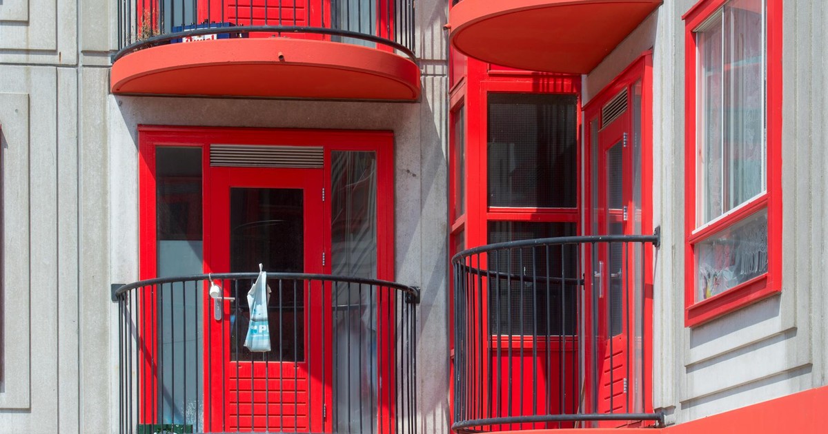 Vibrant red balconies with unique design on a modern residential building facade