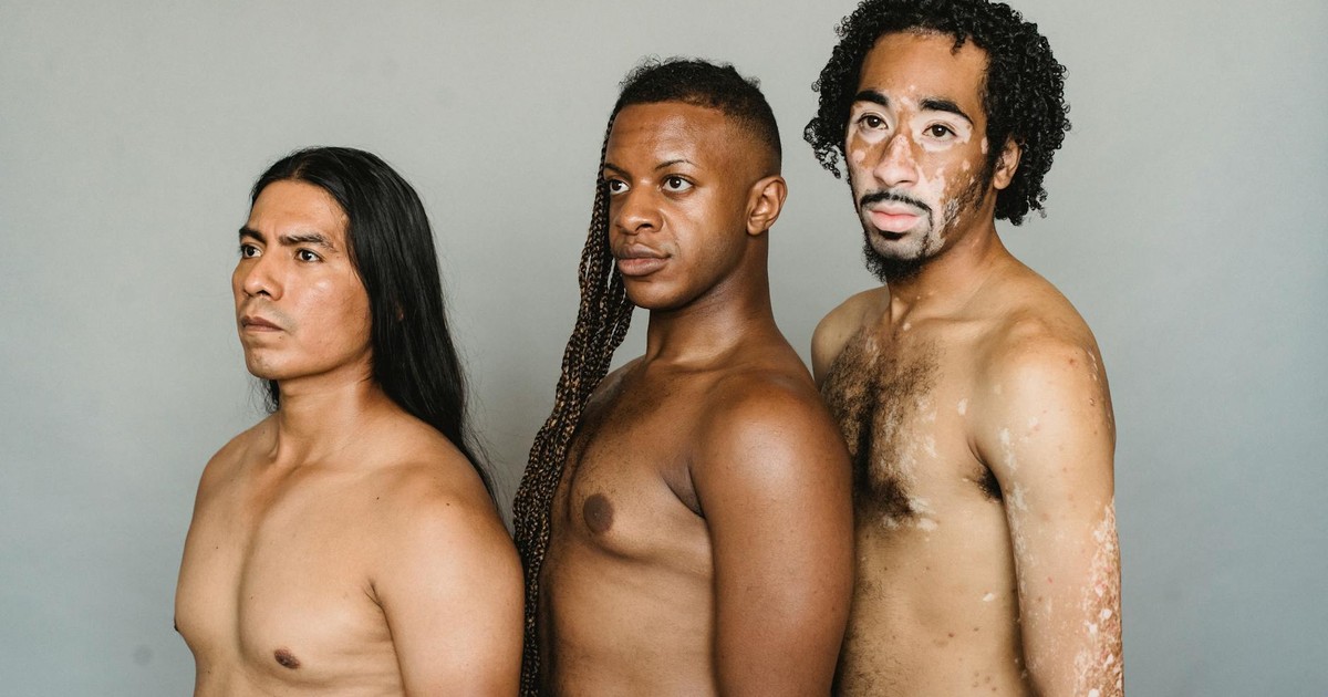 Diverse thoughtful group of friends dreaming and looking away on white background of studio