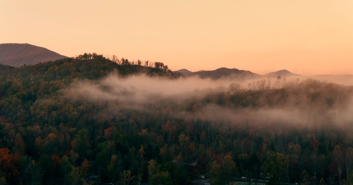A serene mist-covered mountain landscape in Gatlinburg, Tennessee during autumn.
