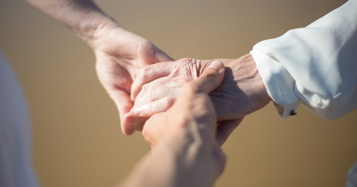 Gentle close-up of intergenerational hands holding, symbolizing connection and care.