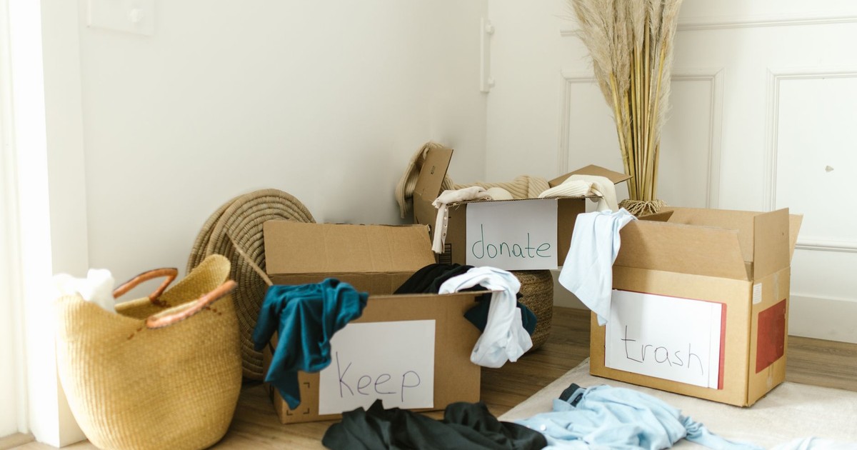 Cardboard boxes labeled 'Keep', 'Donate', and 'Trash' for home decluttering.