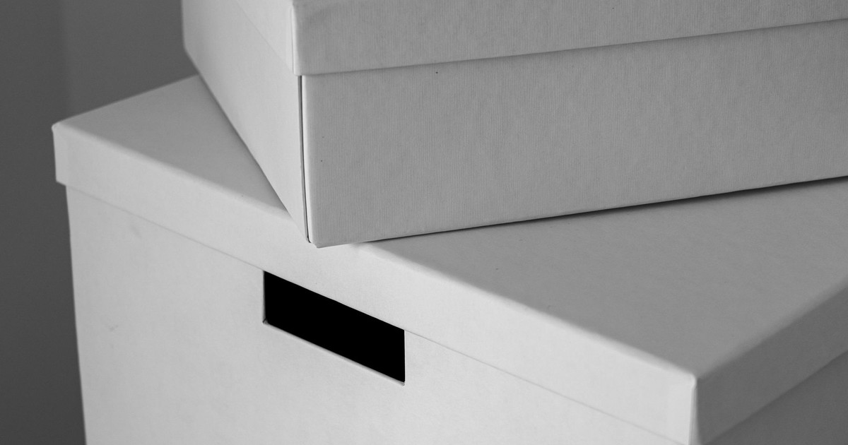 Close-up of minimalist white cardboard boxes stacked with ample copy space. Ideal for design or storage themes.