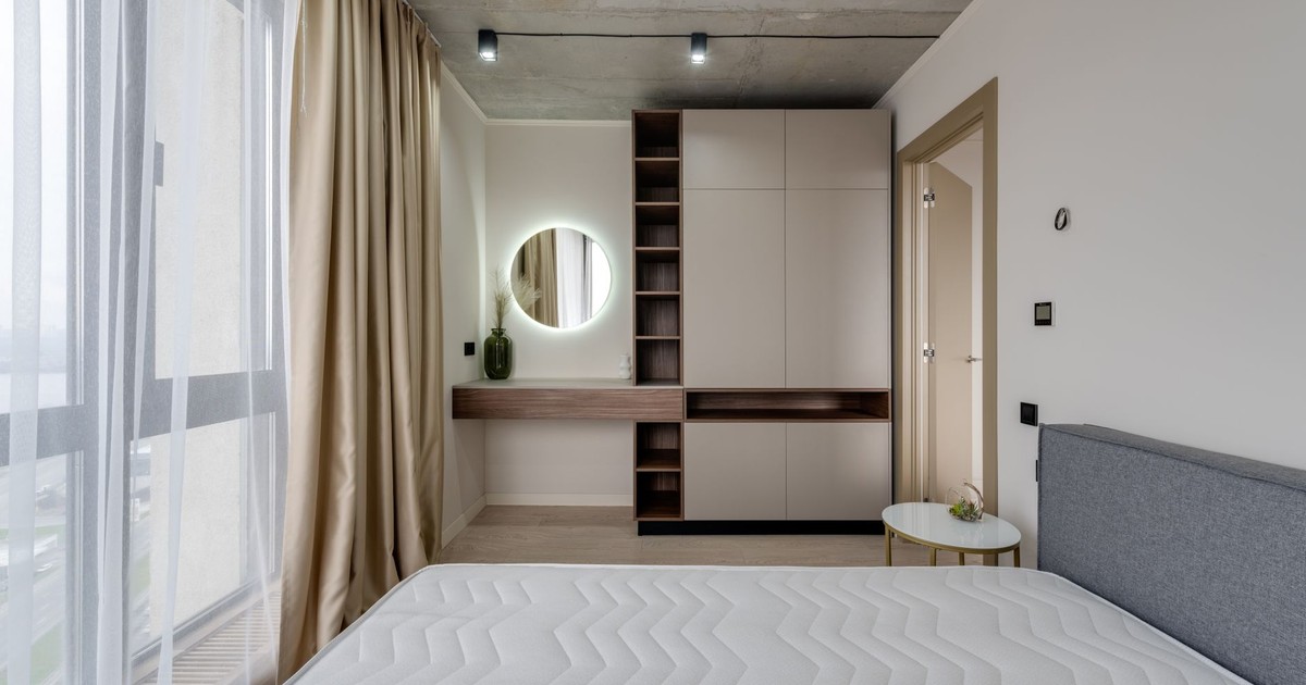 Contemporary bedroom with large window, modern furniture, and stylish decor.