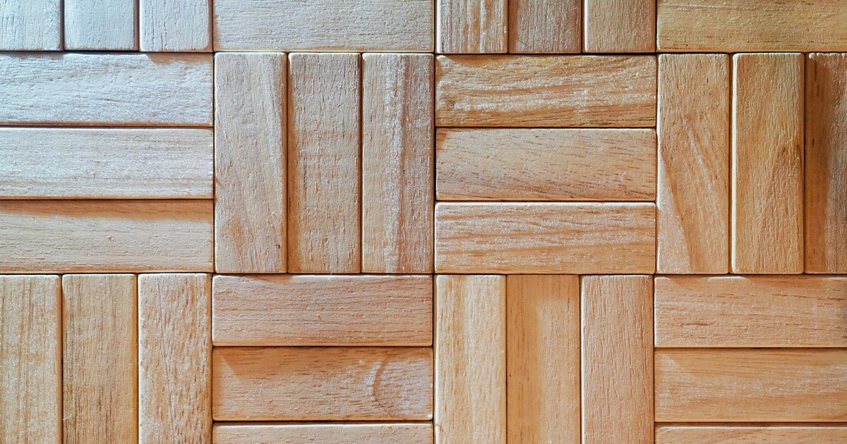 Close-up of intricately patterned wooden parquet with a natural texture and light finish.