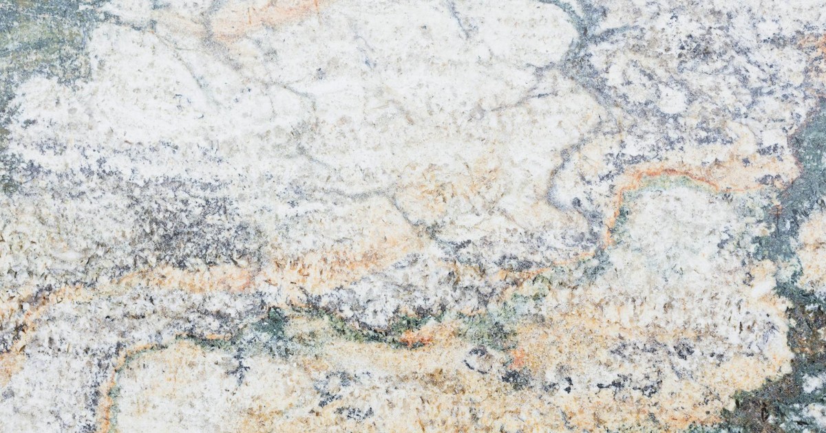Close-up of textured marble surface showcasing unique patterns and earthy tones, ideal for design backgrounds.