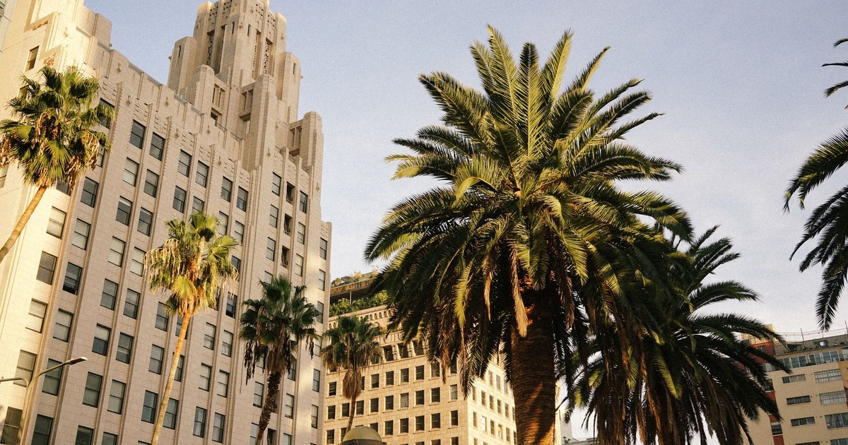 Art Deco architecture with palm trees under a sunny sky, capturing urban beauty and design.