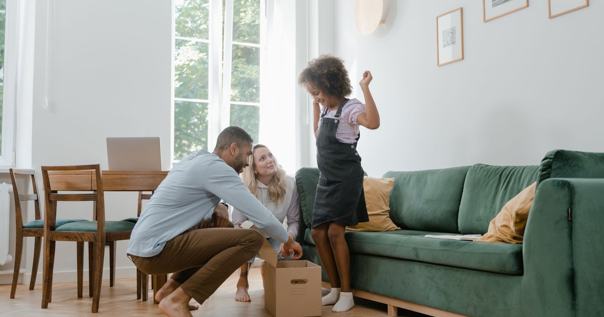 A joyful family unpacking boxes in their new home, embracing togetherness.