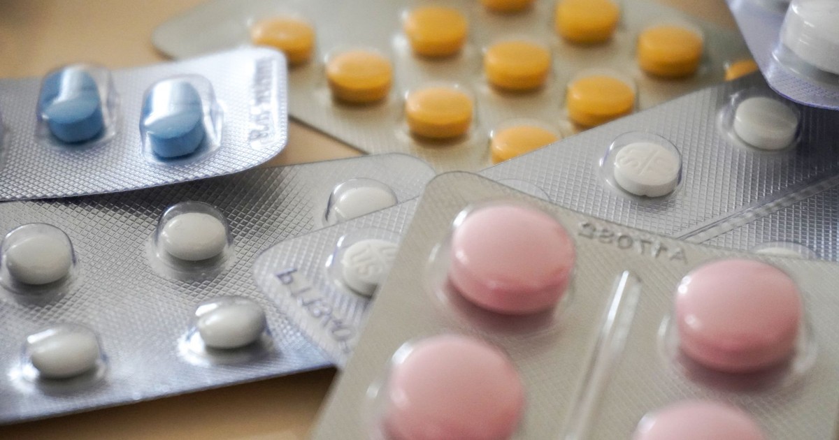 Close-up view of assorted colorful medication blister packs with diverse pills.