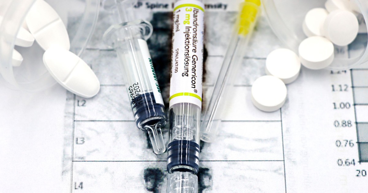 Close-up of syringes and pills on a bone density exam sheet, depicting osteoporosis treatment.
