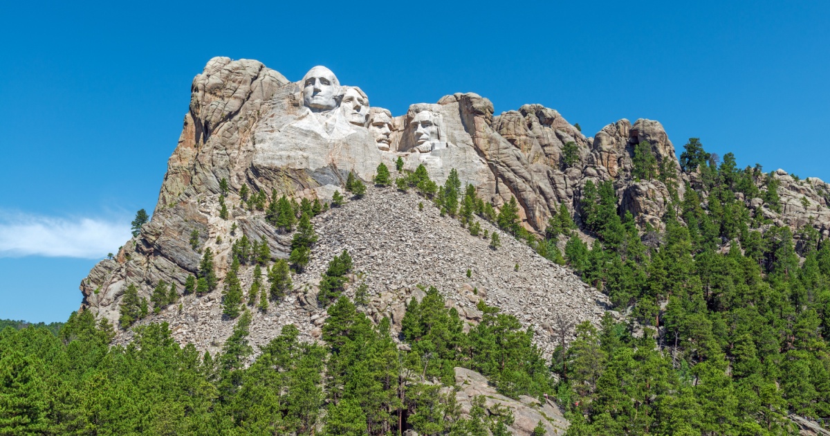 Wide angle view of Mount Rushmore national monument with surrounding forest and nature, Rapid City, South Dakota, United States of America, USA.