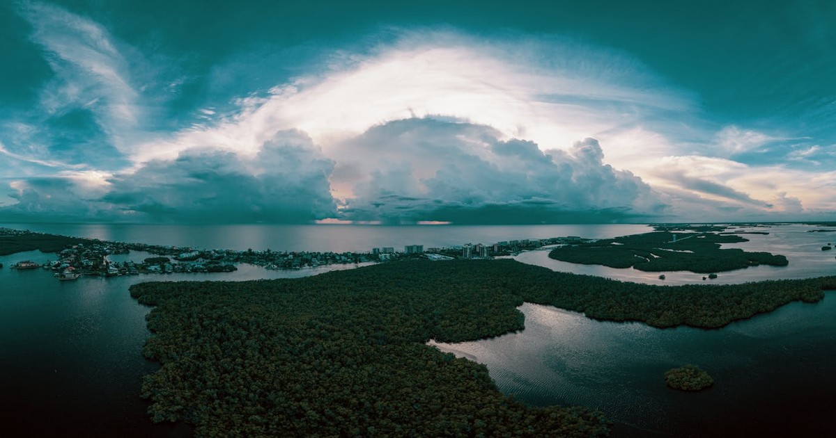 Stunning aerial view of coastal Bonita Springs with dramatic cloud formations and waterways.