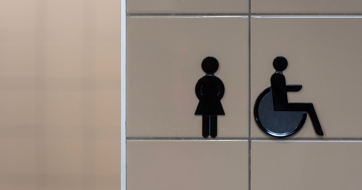 Signage showing symbols for an inclusive restroom with wheelchair accessibility.