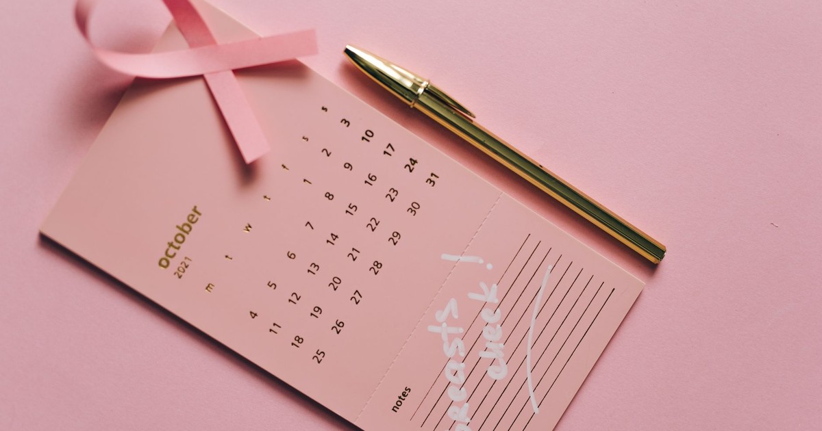 Pink calendar with ribbon and pen for Breast Cancer Awareness in October.