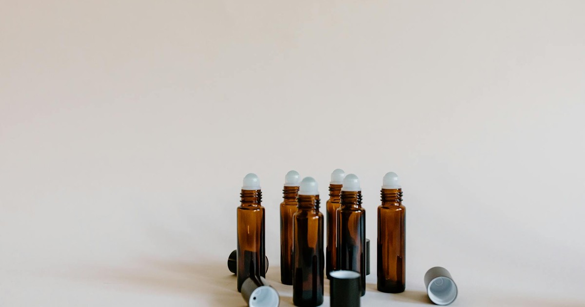 Close-up of brown essential oil roller bottles on a white background, perfect for aromatherapy and holistic wellness.