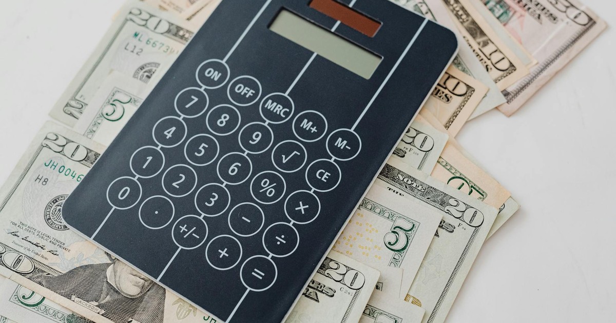 Close-up of a calculator atop US dollar bills, symbolizing financial planning and budgeting.