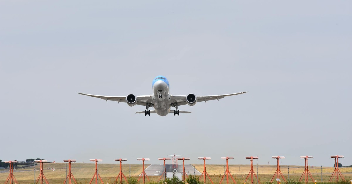 Wide-body airplane taking off from a runway, showcasing aviation and travel themes.