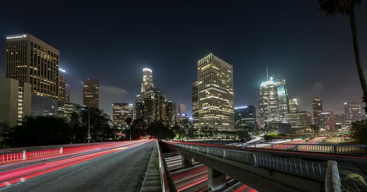 Vibrant long exposure of Downtown Los Angeles skyscrapers at night, showcasing the city skyline.