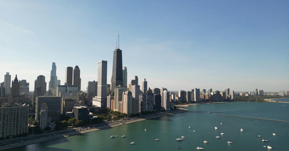 Stunning aerial view of Chicago skyline over Lake Michigan with clear blue skies.