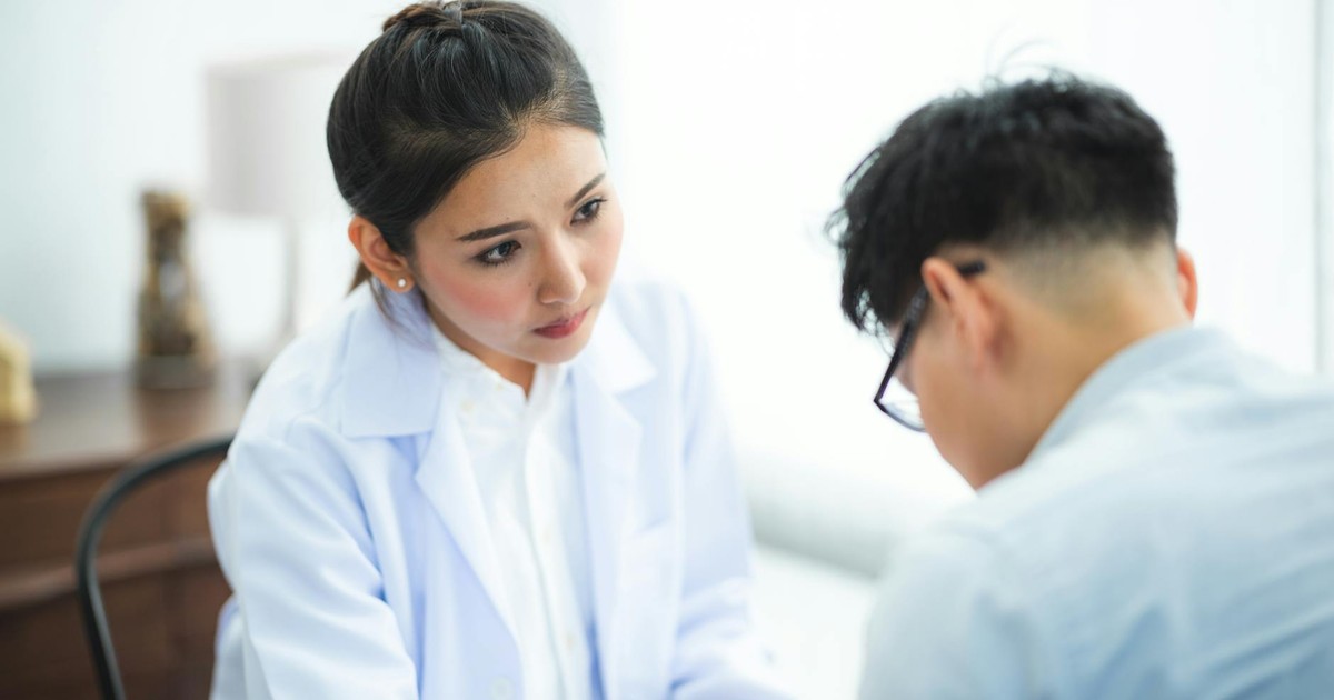 A doctor attentively listens to a patient during a medical consultation, emphasizing care and understanding.