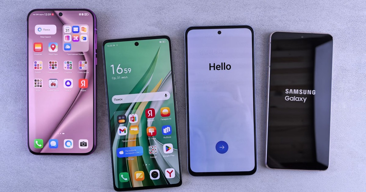 Four modern smartphones showcasing home screens, applications, and startup logos on a sleek surface.