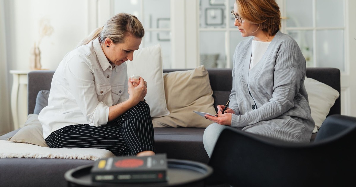 A therapist and client in a counseling session, capturing feelings and support.