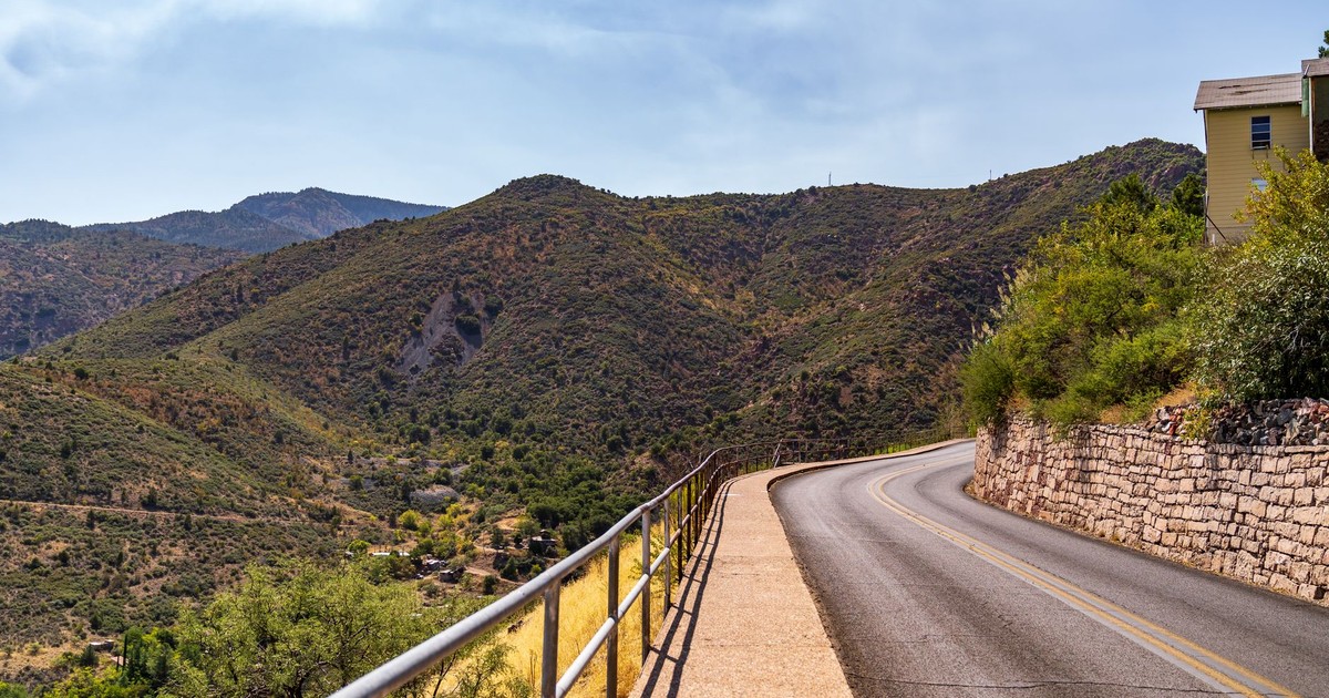 Explore the winding roads of Jerome, Arizona, surrounded by breathtaking mountain views.