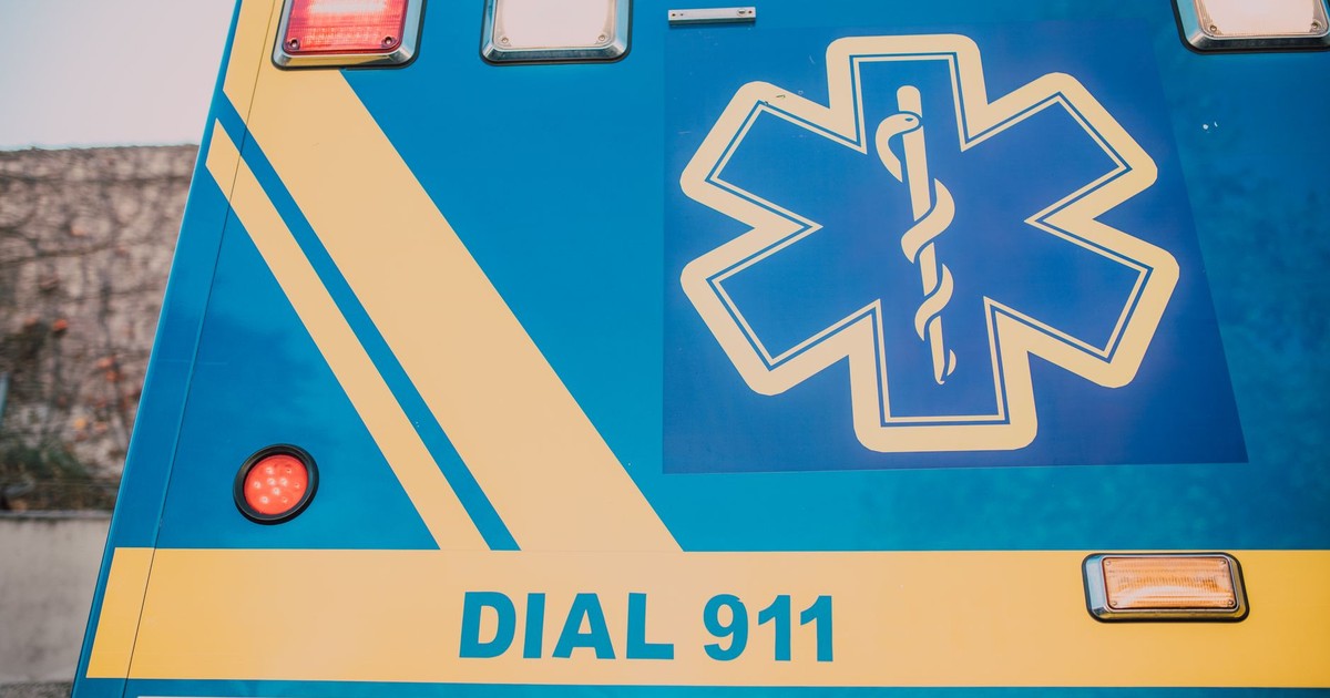 Close-up of an ambulance with star of life symbol and 'Dial 911' text.