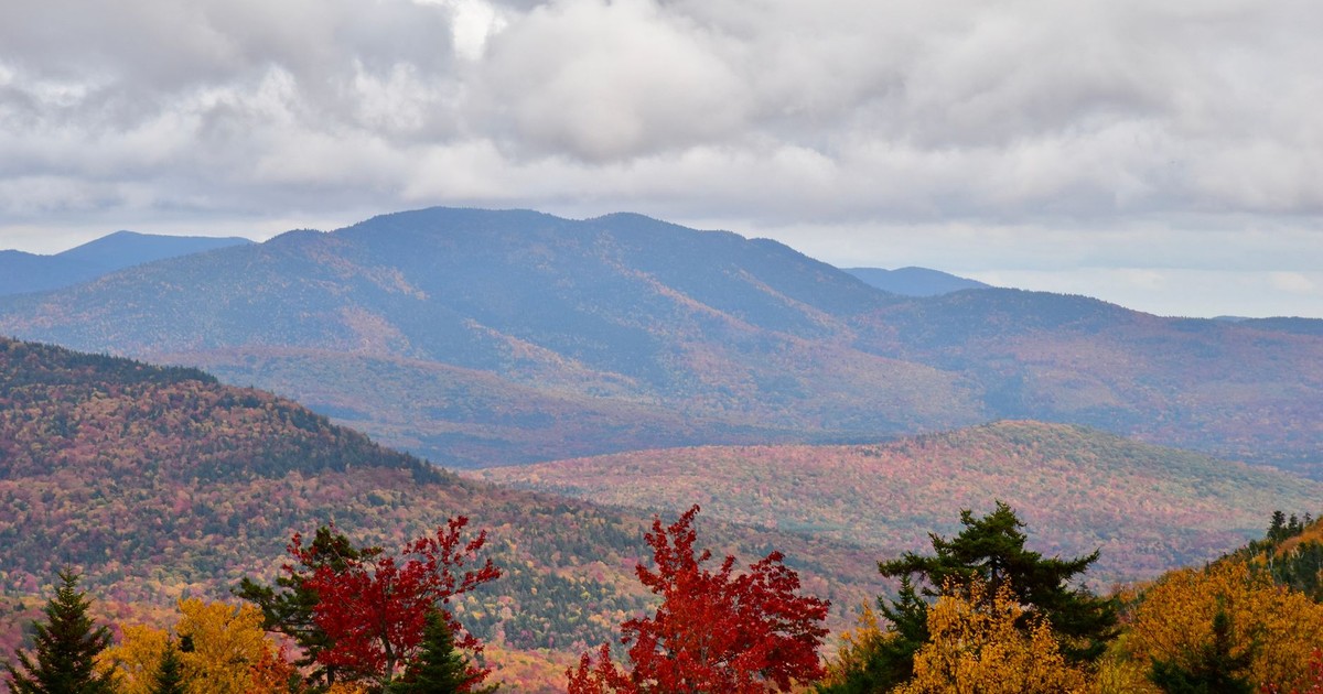 Stunning aerial view of fall foliage in the White Mountains, featuring vibrant colors and scenic landscapes.