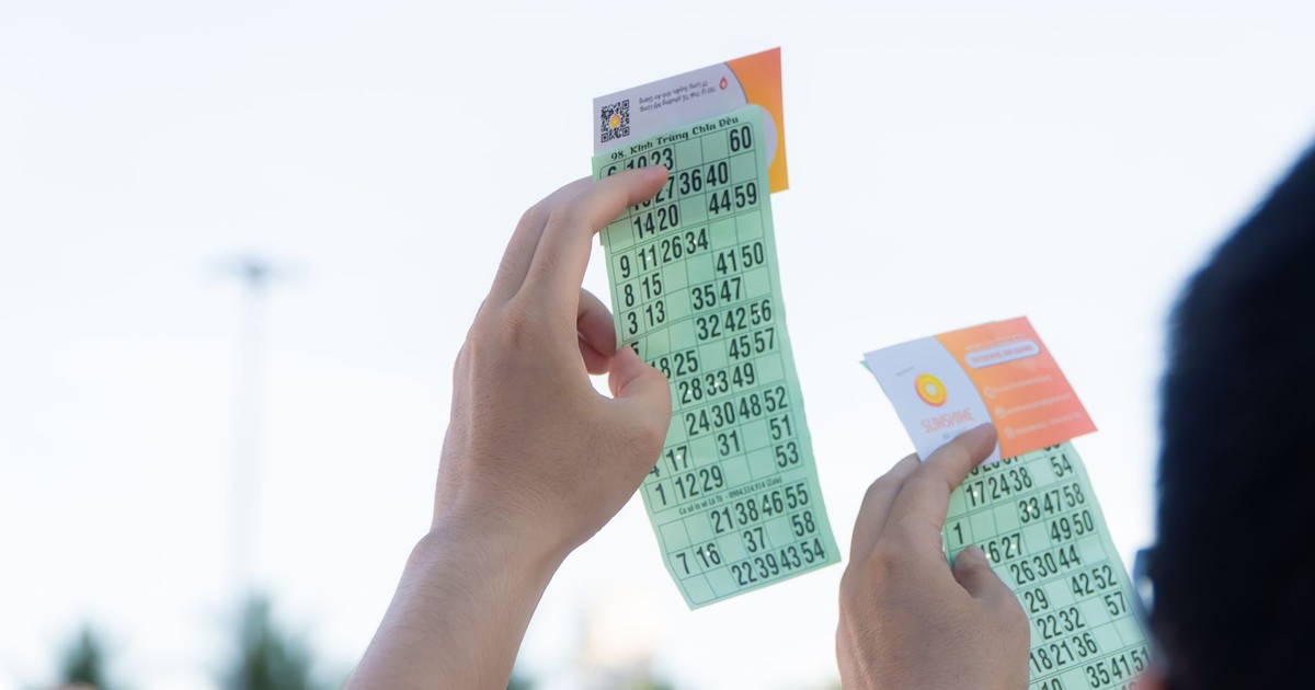 Close-up of hands holding transportation tickets, showcasing numbers and fare details.
