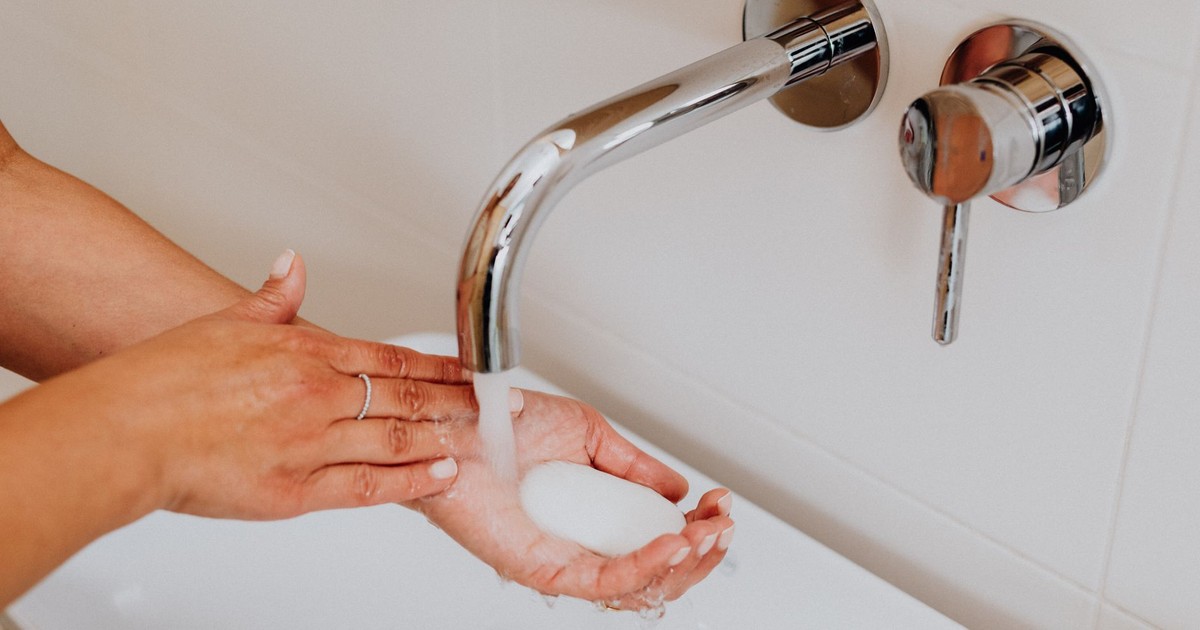 Clean hands with soap under running water promoting hygiene.