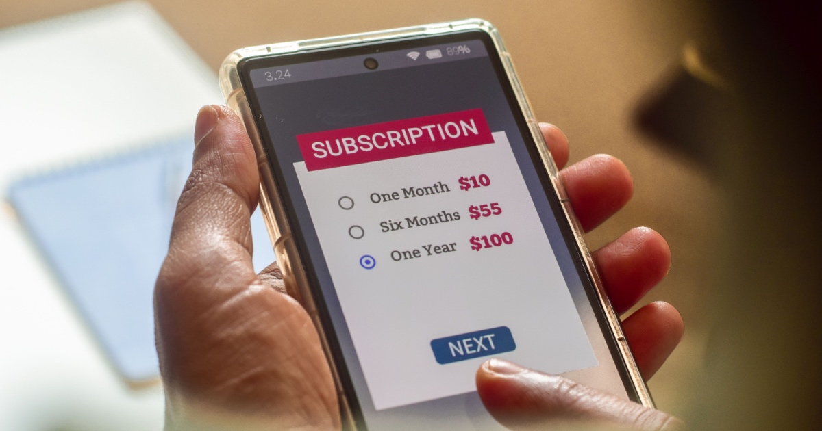 Man choosing a subscription plan for one year using mobile applications for newspaper or delivery or online streaming service.