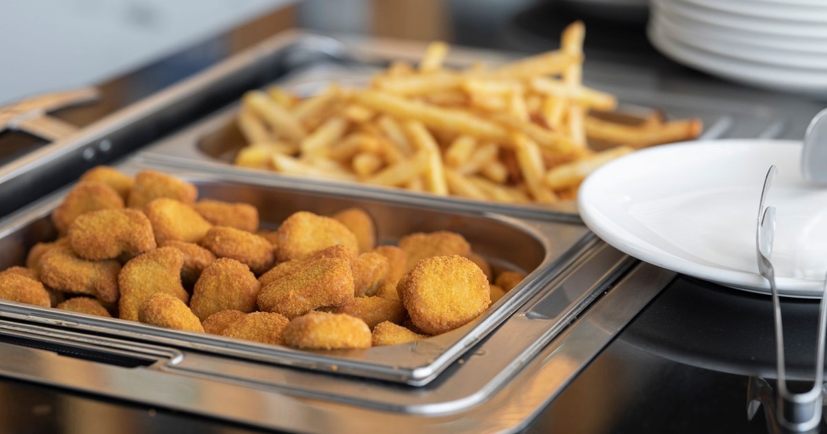 Close-up of crispy nuggets and French fries in a buffet setup, perfect for fast food or catering imagery.