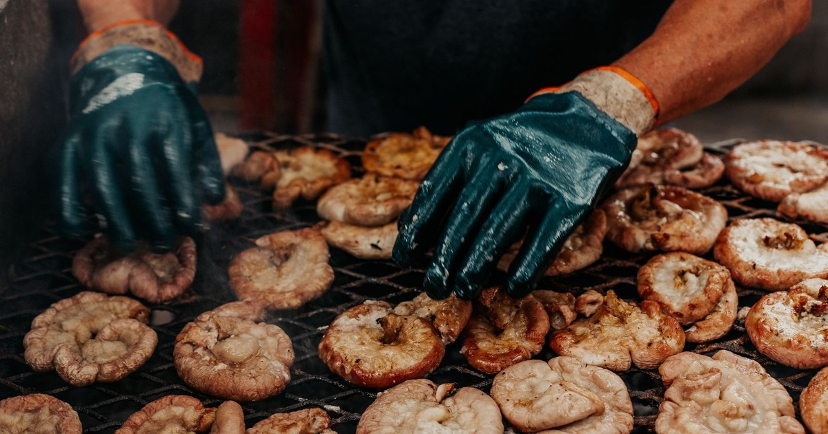 Person grilling traditional Argentine meat in Buenos Aires, showcasing authentic asado preparation.