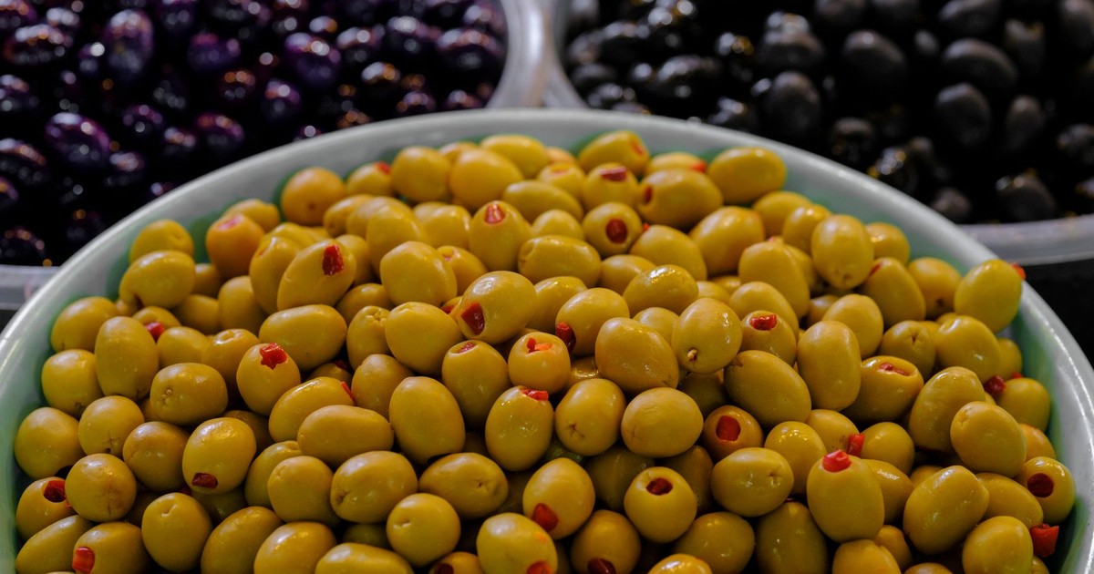 Vibrant variety of green and black olives in bowls; perfect for culinary inspiration and Mediterranean cuisine themes.