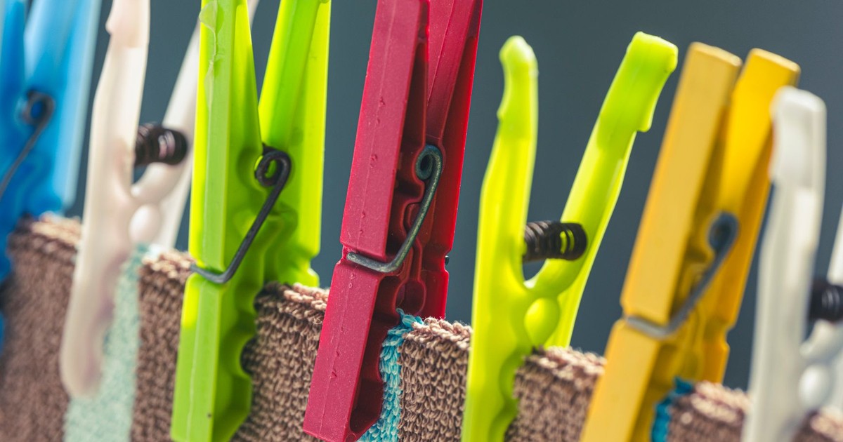 Vivid clothespins hang clothes on a line, showcasing laundry lifestyle essentials.