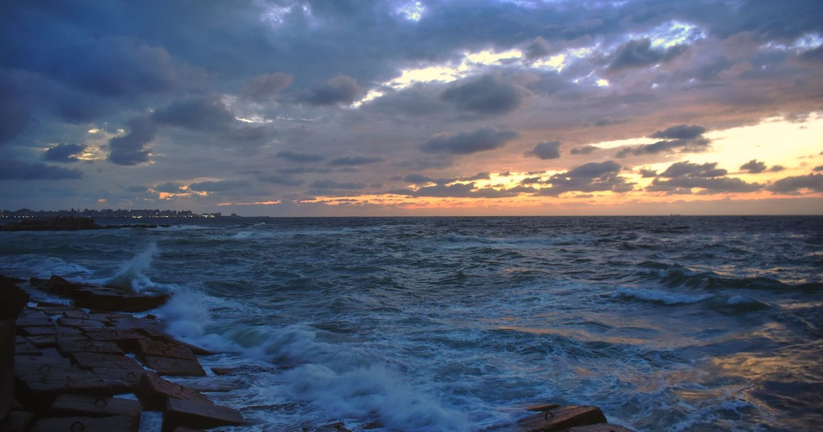 Captivating sunset over the Mediterranean Sea in Alexandria, highlighting clouds, waves, and vibrant skies.