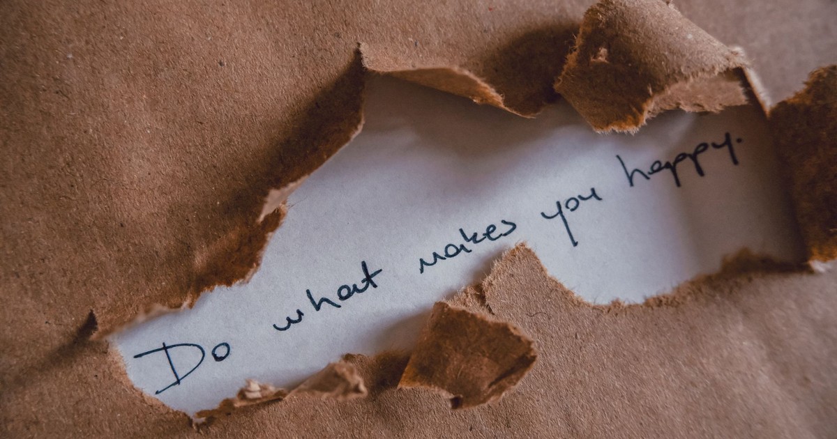 Brown paper revealing message 'Do what makes you happy.'